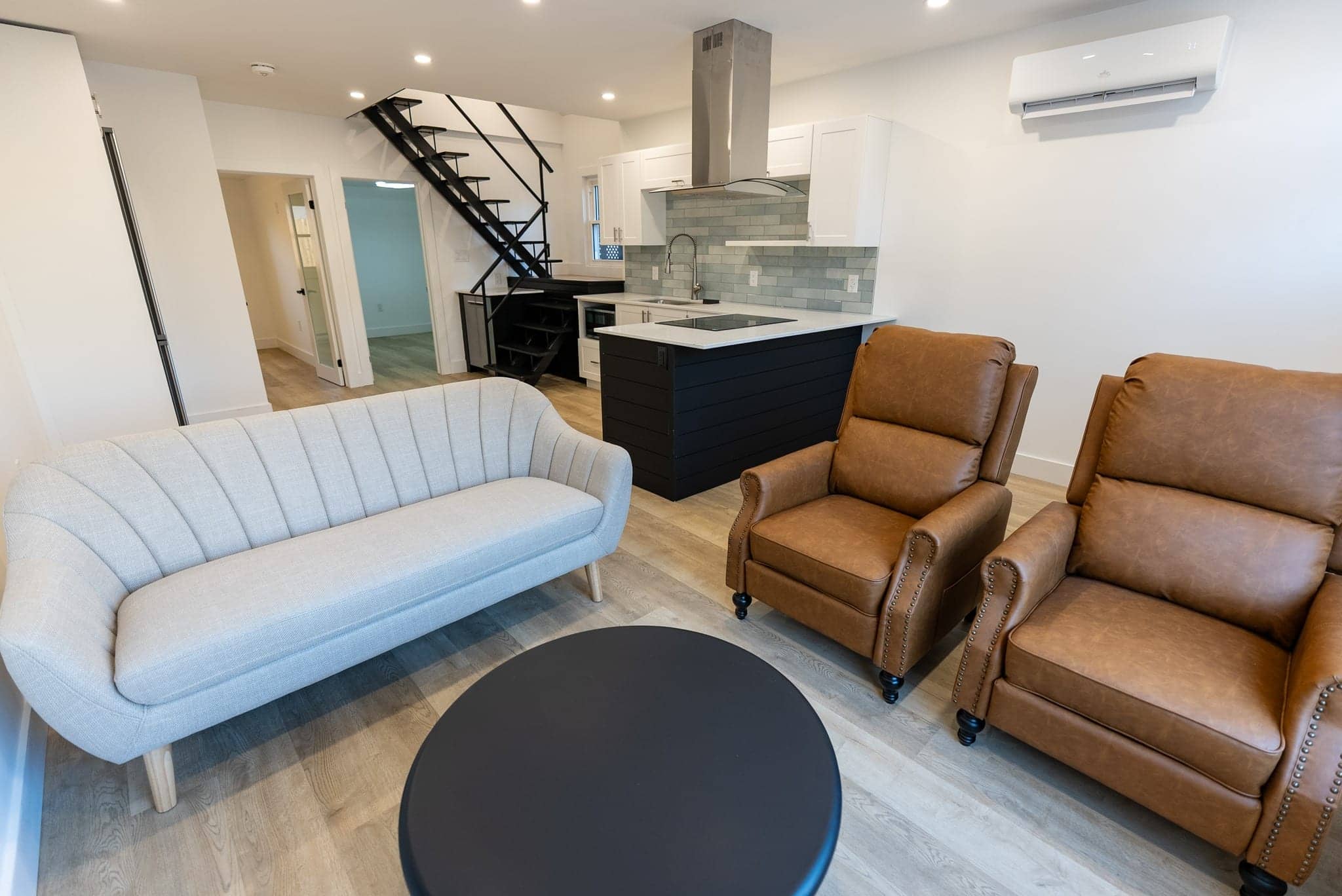 Open-concept living and staircase in a Westport four-season cottage conversion.