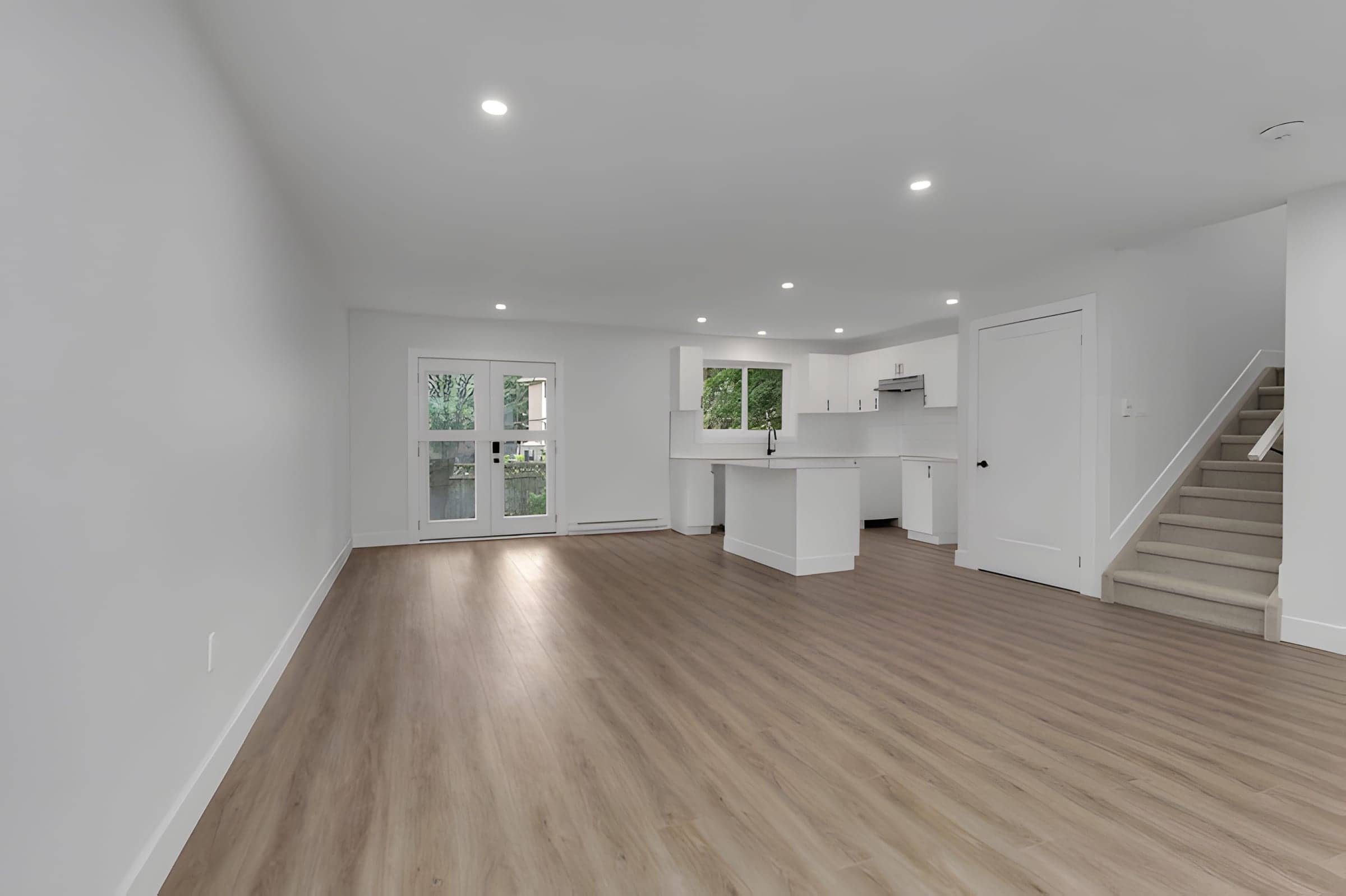 Finished basement suite with open kitchenette and stair