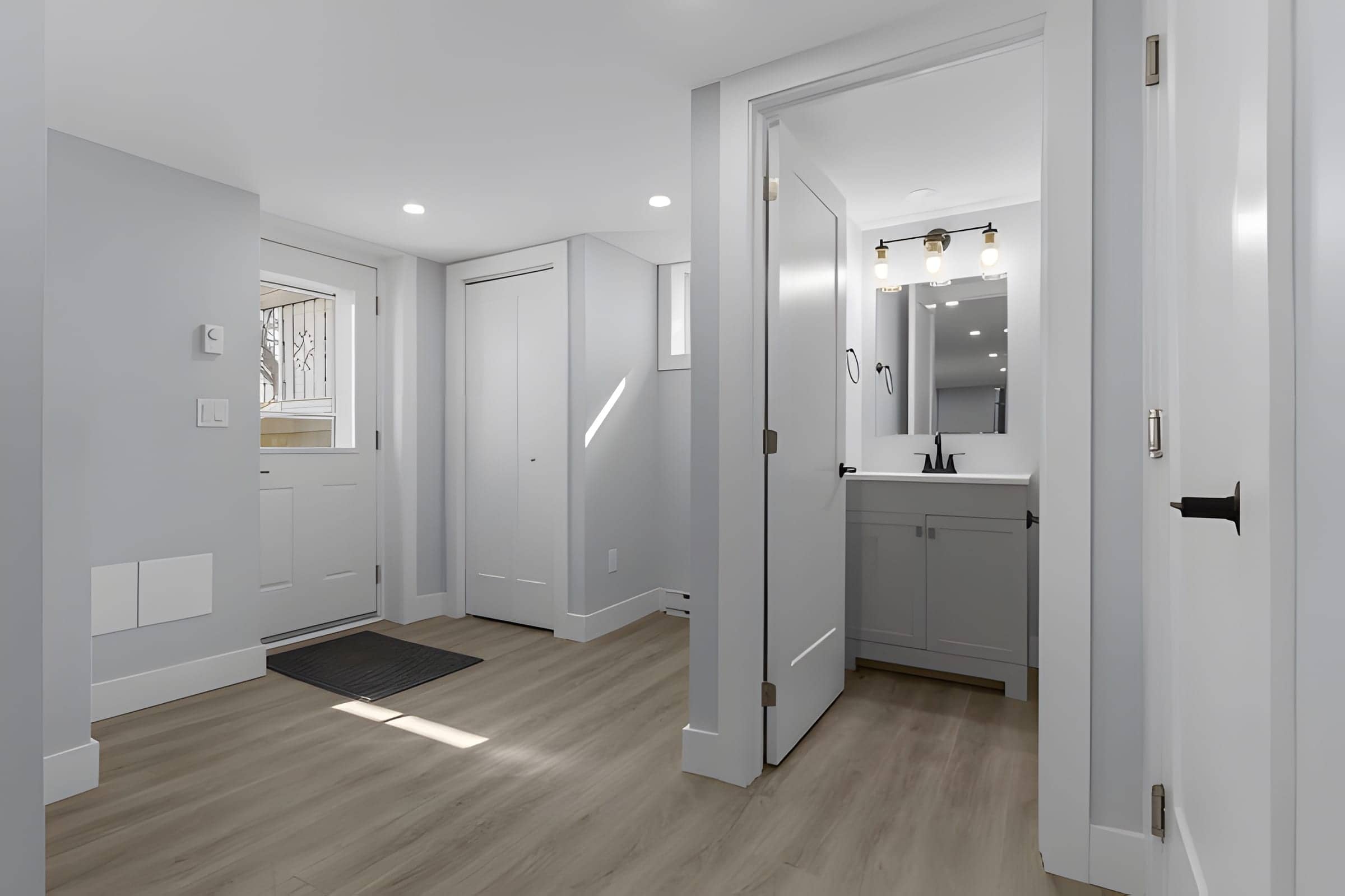 Bright entryway with adjoining powder room